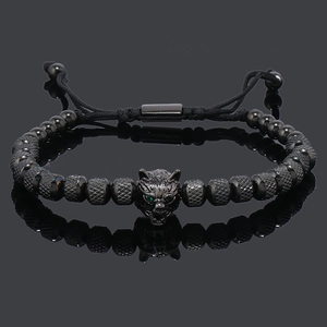 Detail of beaded wolf head bracelet with green crystal eyes and adjustable cord