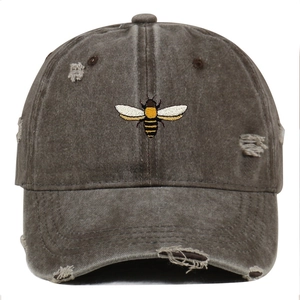 Distressed wash cotton baseball cap with detailed bee embroidery and vintage frayed edges