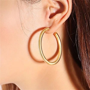 Minimalist golden C-shaped tube hoop earrings for women with polished metal finish