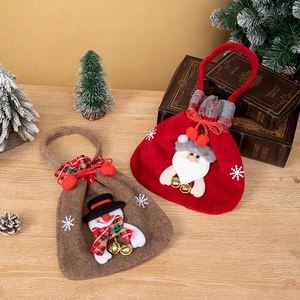 Detail of felt Christmas gift bags with 3D Santa and Snowman designs and gold bells