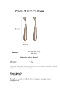 Detail view of gold drop pearl earrings showing dimensions 6.2cm long and 0.9cm wide