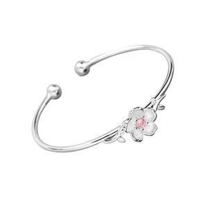 Silver plated cherry blossom open bangle with pink crystal center on white background