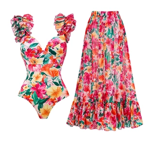 Detail of floral one-piece swimsuit with matching long skirt in tropical print