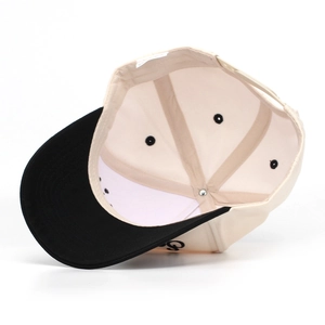 Detail view of cotton baseball cap with side embroidery and inner label structure