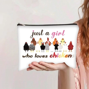 Detail of hand-held canvas makeup bag featuring colorful chicken print and secure black zipper