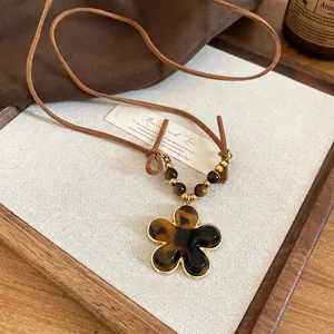 Retro resin flower pendant necklace with tiger eye beads and brown suede cord