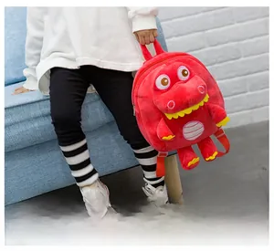 Detail of red plush dinosaur backpack for toddlers showing facial features and adjustable straps