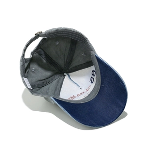 Detail of the baseball cap inner lining with reinforced stitching and adjustable metal buckle