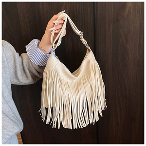 Detail of off-white tassel shoulder bag with adjustable strap and premium metal hardware