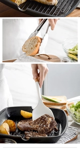 Close-up of cream silicone spatula with wooden handle and metal food tongs in modern kitchen