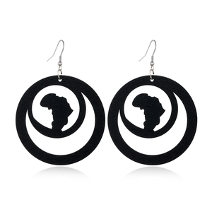 Detail of black hollow wood earrings with African map cutouts and crescent shapes