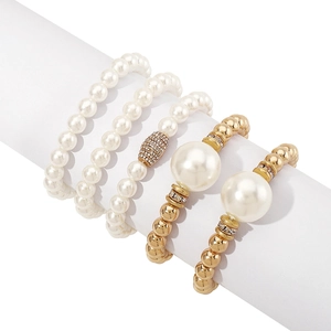 Detail of 5-piece multilayer stretch pearl bracelet set with gold beads and rhinestones