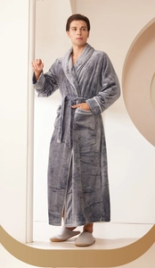 Close-up of grey plush flannel bathrobe featuring white contrast piping and soft texture