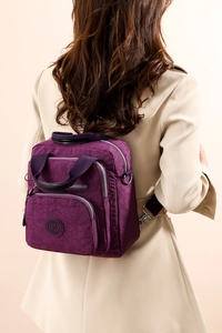 Vue arrière du sac à dos à langer violet en nylon avec plusieurs poches et bretelles réglables