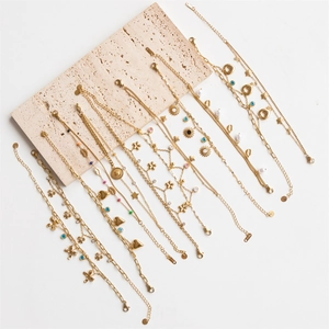 Set of 11 gold stainless steel charm bracelets with evil eye, heart and sun flower pendants