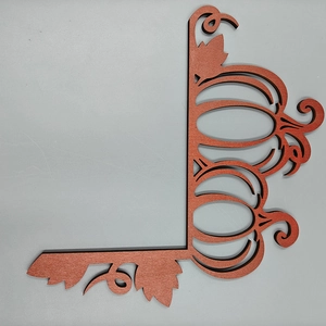 Detailed view of Halloween orange wooden door corner decoration with pumpkin and leaf carving