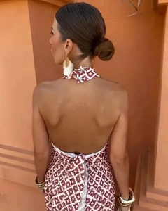 Close-up of halter neck tie and open back detail with red geometric print dress