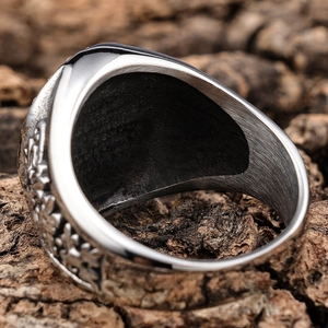 Macro shot of retro stainless steel lion ring with detailed relief patterns and textures