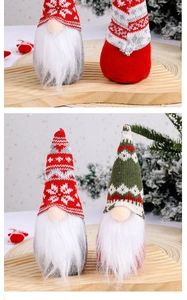 Detail of Christmas gnomes with knitted snowflake hats and long white beards on wood