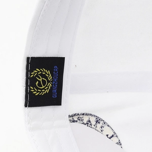 Macro detail of breathable white baseball cap inner sweatband and embroidered brand label