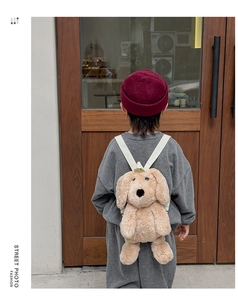 Toddler plush puppy backpack with soft brown faux fur and adjustable white straps on a child