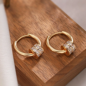 Chic 18k gold plated hoop earrings with pave cubic zirconia beads on a wooden display