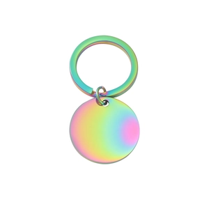 Close-up of circular stainless steel keychain with vibrant rainbow mirror finish coating