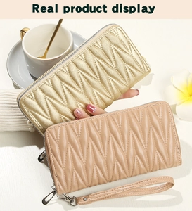 Detail of geometric quilted faux leather long wallets in gold and nude pink with zippers