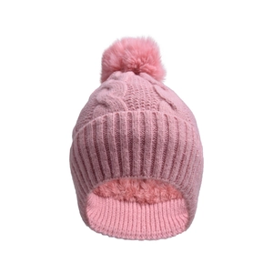 Detail of pink cable knit beanie with faux fur pom pom and warm fleece lining