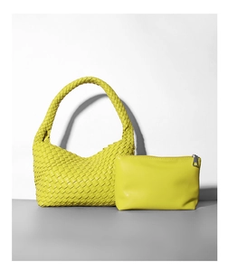 Dettaglio macro della borsa hobo in pelle intrecciata giallo limone con bustina abbinata