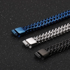 Detailed close-up of woven stainless steel dragon bone bracelets in blue, silver and black