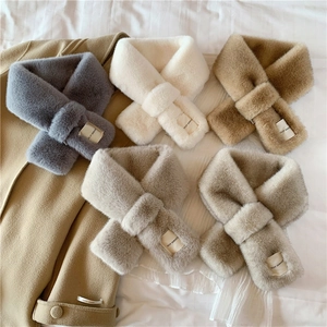 Detail of plush faux rabbit fur scarves in five neutral colors with soft texture and brand label