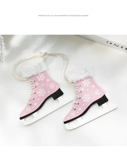 Detail of two pink wooden ice skate Christmas ornaments with snowflakes and fur trim