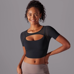 Detail of black sports crop top with mesh stitching and moon-shaped cutout design