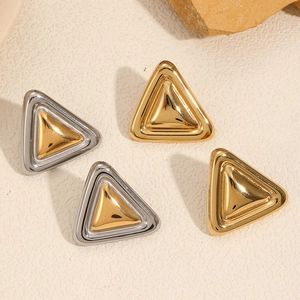 Detail of 18k gold and silver toned triangular stainless steel stud earrings set