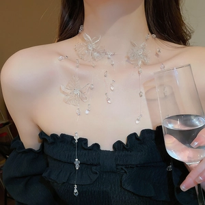 Close-up of floral tassel necklace with transparent flower and teardrop pendants
