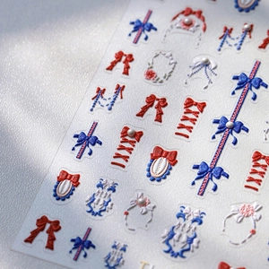 3D embossed nail art stickers with red and blue bows and pearls on white background