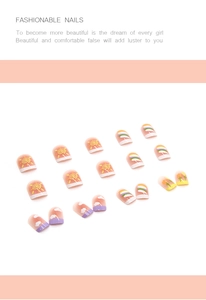 Close-up of cute cartoon press-on nails with sun and rainbow hand-painted patterns