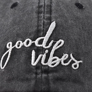 Washed cotton baseball cap with white Good Vibes embroidery on a dark grey vintage fabric