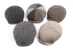 Detailed view of classic herringbone newsboy caps in five distinct vintage color patterns