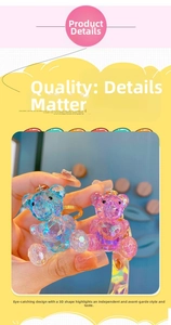 Detail view of faceted crystal-style resin bear charms with golden metallic keychains