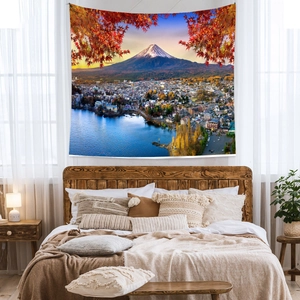 Detailed view of Mount Fuji landscape tapestry with autumn maple leaves over a cozy bed