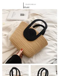 Detail of khaki woven cotton rope tote bag with black handles on white fabric