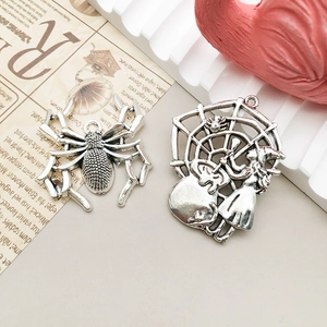 Detail of gothic style antique silver spider and witch cauldron alloy pendants