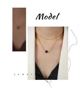 Detail of double-layer gold beaded chain with dark green square agate pendant