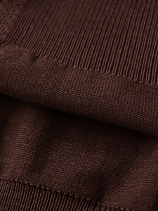 Detailed macro view of dark brown knit fabric showing fine texture and rib stitching