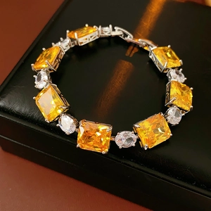 Detailed macro of silver bracelet with yellow square zircon and small white gemstones
