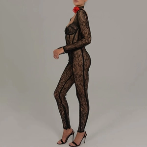 Detail of black floral lace jumpsuit with sheer long sleeves and slim fit bodycon silhouette