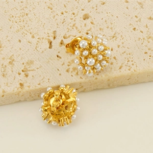 Detailed view of 18k gold pearl stud earrings showing the front design and butterfly backings