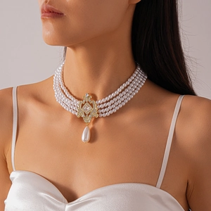 Detail of baroque multi-layer pearl necklace with gold flower buckle and crystal drop